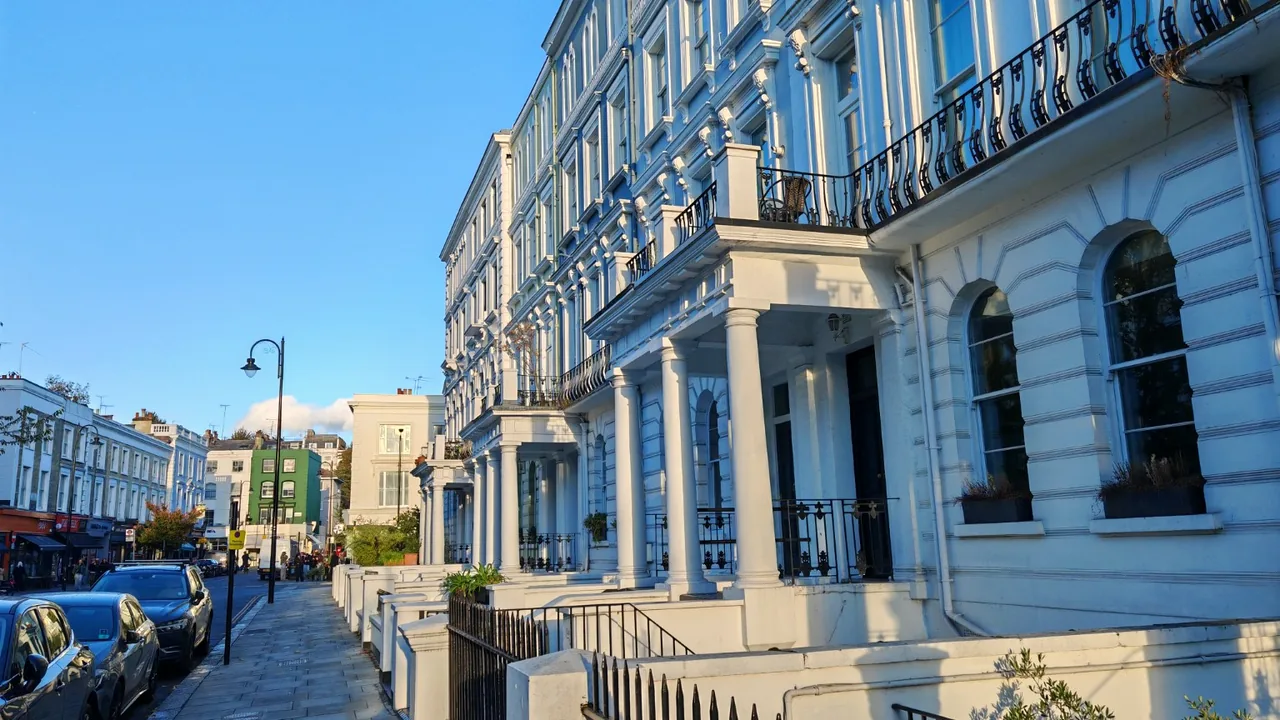White period townhouses and shopfronts on a London street